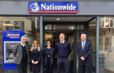 Pictured, Michael Gove with members of Nationwide Building Society's Camberley branch